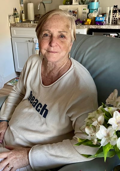 Senior woman sitting comfortably in a cozy room.