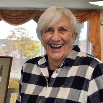 Resident smiling in a common area.