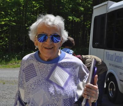 Senior woman outdoors wearing sunglasses and smiling