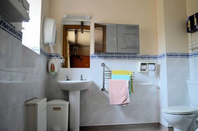 Clean bathroom with sink, toilet, and towels