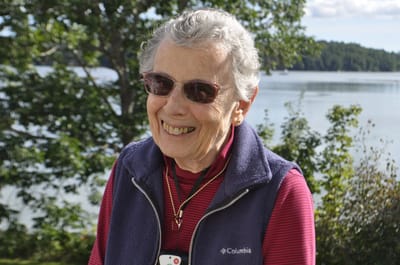 Smiling senior woman outdoors by the water