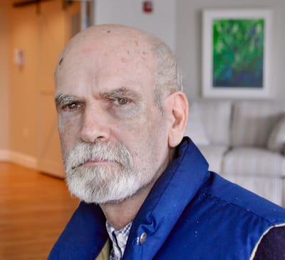 Close-up portrait of a senior man indoors