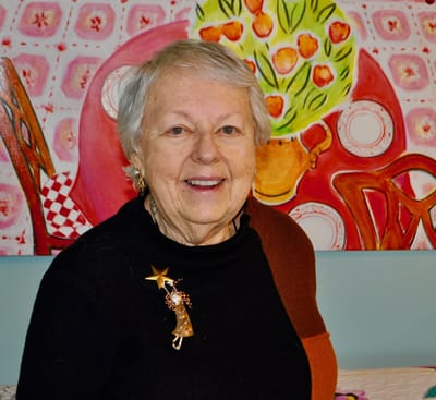 Smiling senior woman with a colorful background.