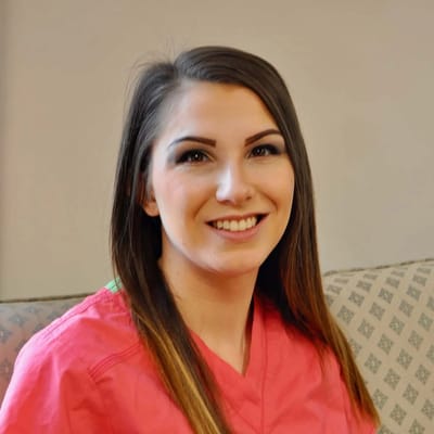 Healthcare staff member smiling in a common area.