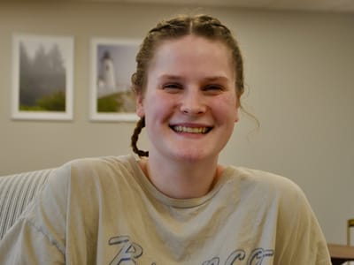 Smiling staff member in a common area.