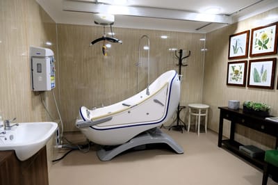 Assisted bathing equipment in a care facility room.