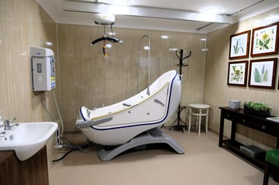 Specialized bathing equipment in a facility bathroom.