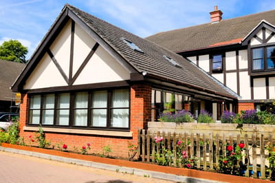Charming building exterior with garden flowers.