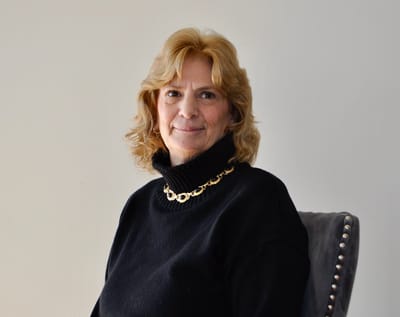 Portrait of a smiling woman in a black sweater.