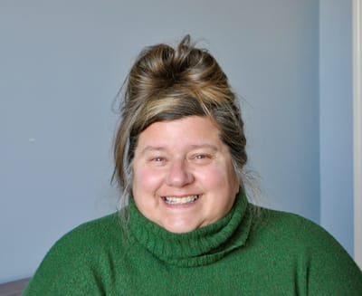 Smiling woman in a cozy green sweater