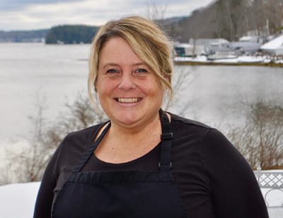 Staff member smiling near the water