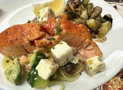 A plated meal featuring salmon and vegetables.