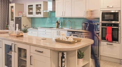 Modern kitchen with a staff member in motion.