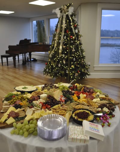 Holiday buffet spread in a decorated common area.