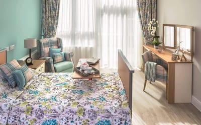 Bright and cozy resident bedroom with floral decor.