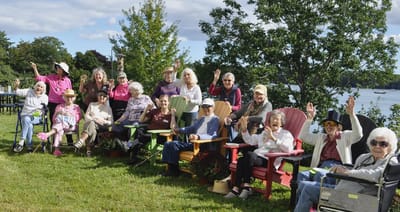 Residents enjoying an outdoor gathering by the water.