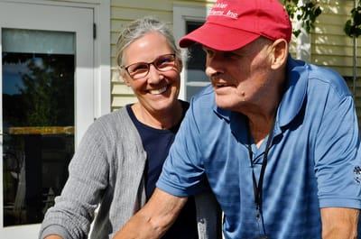 A caregiver and resident enjoying outdoor time together.