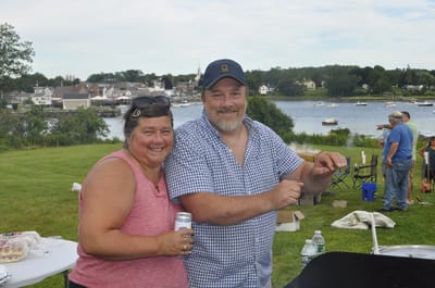 Residents enjoying a community barbecue by the water