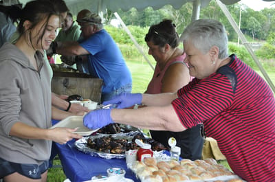 Residents and staff enjoying a meal outdoors