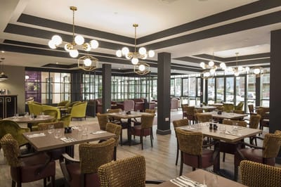 Elegant dining area with modern furniture and lighting.