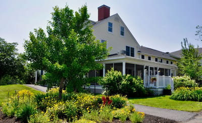 Exterior view of The Lincoln Home with garden and porch.