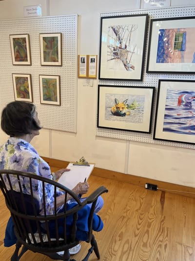 Resident engaging with artwork in an interior space.