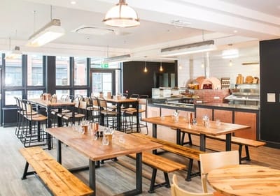 Modern dining area with wooden tables and bar seating.