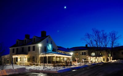 Exterior of The Lincoln Home illuminated at night.