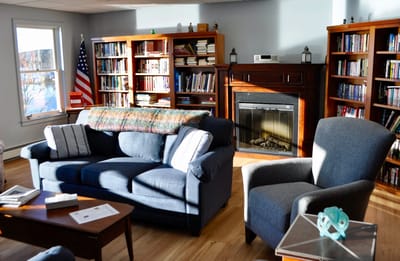 Cozy common area with bookshelves and fireplace