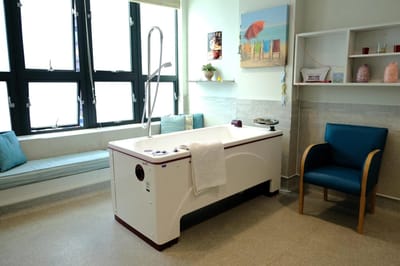 Therapeutic bath area in a bright interior space.