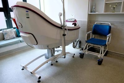 A bathing chair and shower area inside a care facility.