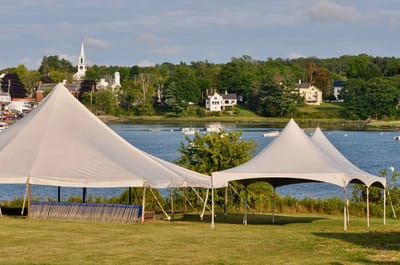 Tents set up near a waterfront view.
