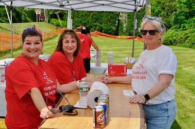 Staff members celebrating at an outdoor event.