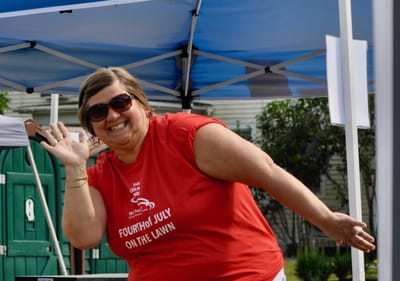 Staff member enjoying an outdoor celebration.