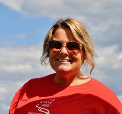 Staff member wearing a red shirt outdoors