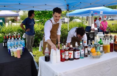 Bartenders preparing drinks at an outdoor event