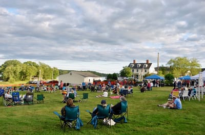 Community event with residents and guests enjoying outdoor activities.