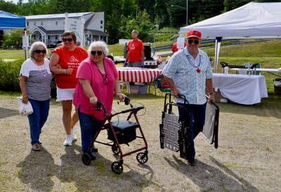 Residents enjoying an outdoor event with staff.