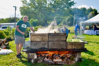 Residents and staff preparing food outdoors.