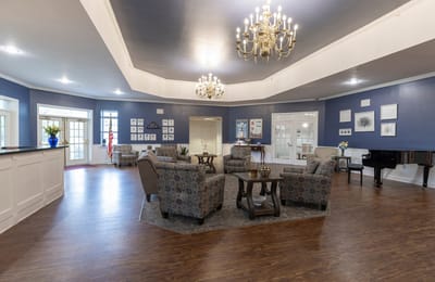 Bright common area with comfortable seating and chandelier