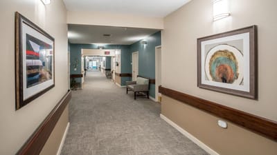 Interior hallway with framed artwork and seating