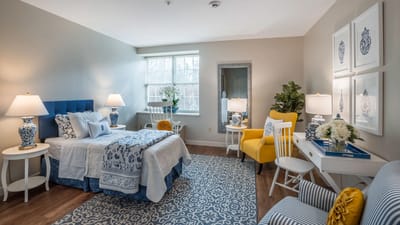 Brightly decorated resident room with cozy furnishings