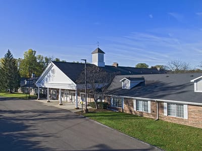 Exterior view of assisted living facility with clear sky
