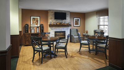 Cozy common area with seating around a fireplace