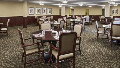 Dining area with tables and chairs set for meals