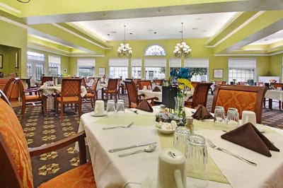 Interior view of a dining room with tables set for meals