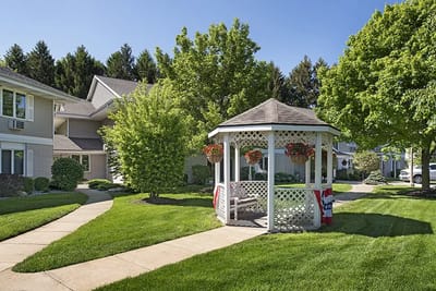 A gazebo surrounded by lush greenery in the facility garden