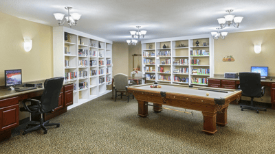 Common area with bookshelves and a billiard table