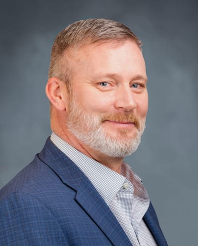 Man with a beard wearing a suit