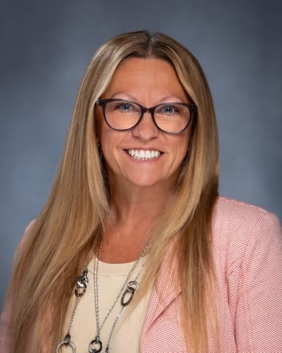 Portrait of a smiling woman with long hair and glasses